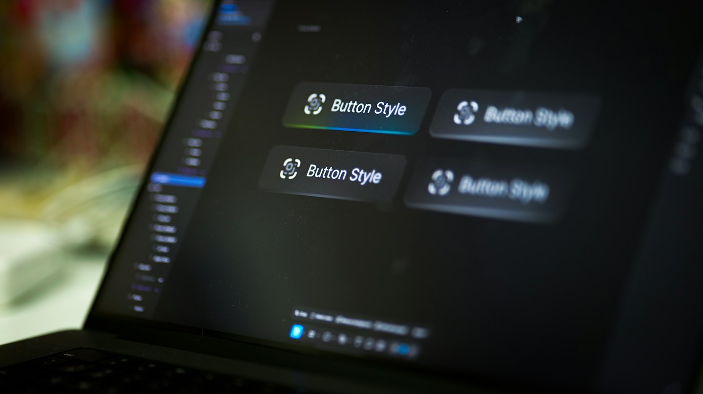 Laptop screen shows web design interface with button styles.